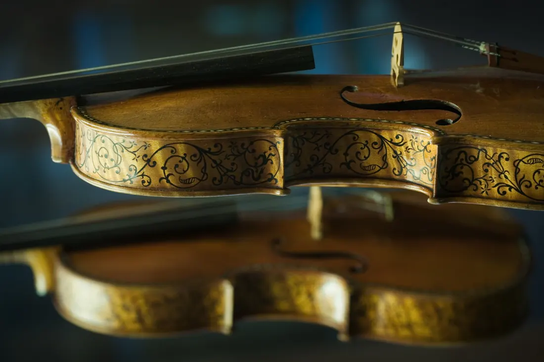 Two baroque violins displayed side by side
